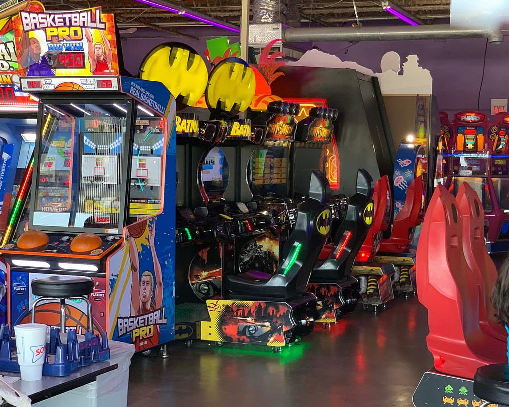 A large arcade room with lots of arcade game machines