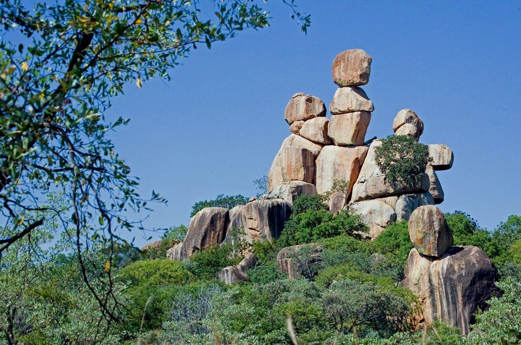 arranged rocks on a green hill in one of the tourist places to visit in Francistown, Botswana