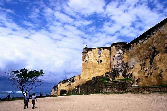 a brown abandoned building under a blue and white sky in beautiful spots to have fun in Kenya