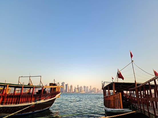 boats in an ocean during daytime in top places to have fun in Doha, Qatar