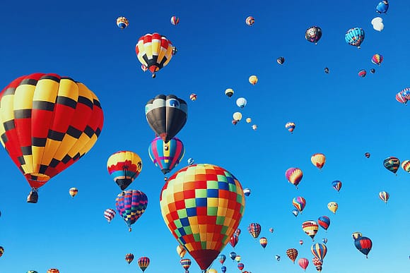 Multiple colored hot air balloons in the sky