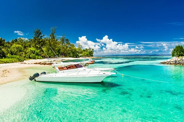 Clear waters with a boat on the waters on  an island 
