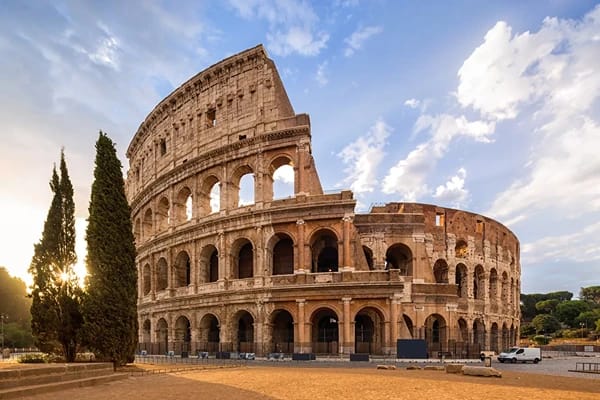 The colosseum in Rome  during the day under a clear blue skiy