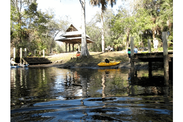 A lake with people kayaking