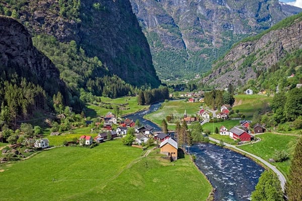 Flam in Norway. Beautiful with flowing waters, little spaced houses, and lots of mountains with green vegetations