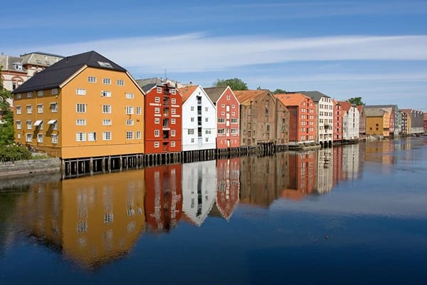 Nidelva River showing beautifully colored houses by the riverside.
