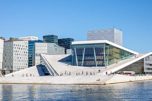 Oslo Opera House with Tourists at the entrance and a body of water