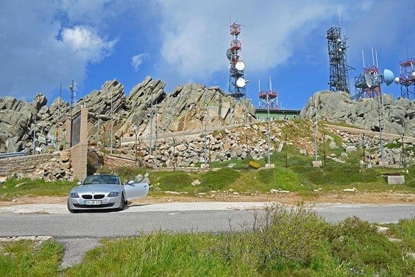 Monte Limbara mountains with telecommunication masses around and a car parked close by