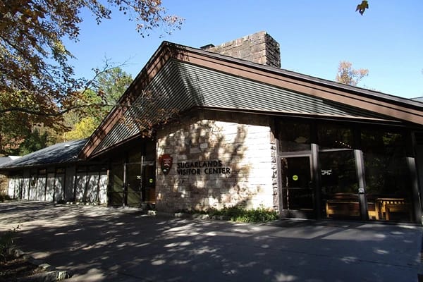 The Sugarlands visitor center building with trees surrounding it