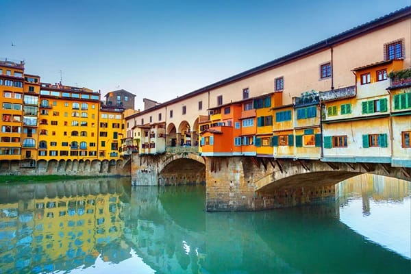 Colourful buildings over a bridge and surrounded by water