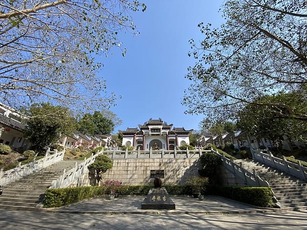 a large white temple with tall staircases in one of the fun places to visit in Shantou, China. 