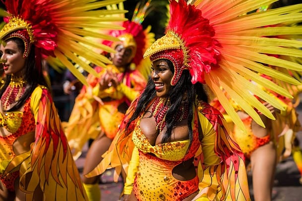 A photo of some beautiful black women in bright yellow and red cultural wears