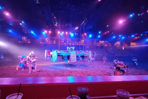 A stage with people wearing different costumes with fighting tools