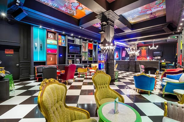 A bar with sci-fi looks, colourful chairs and lights