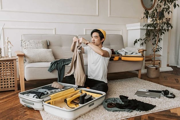 A man packing his clothes for travel