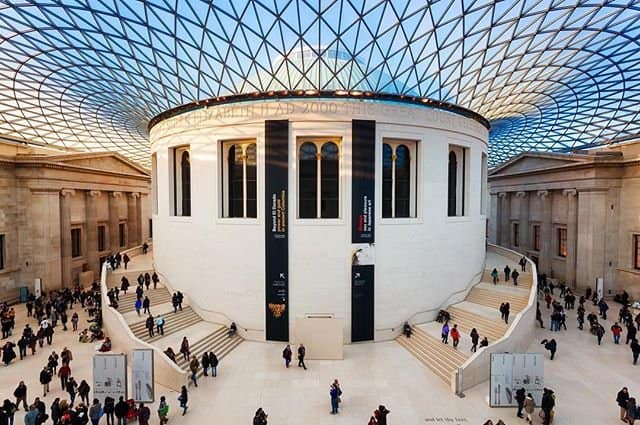 An architectural piece in the British Museum, UK with tourists moving around