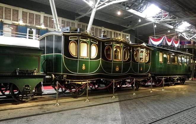 green parked carriages in a building