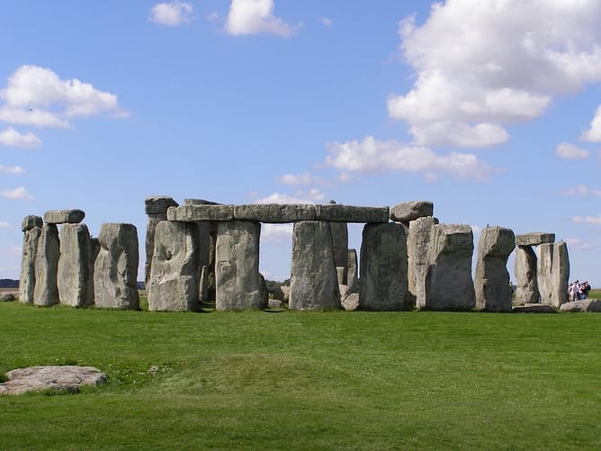 A scenic photograph of Stonehenge over a clear blue sky