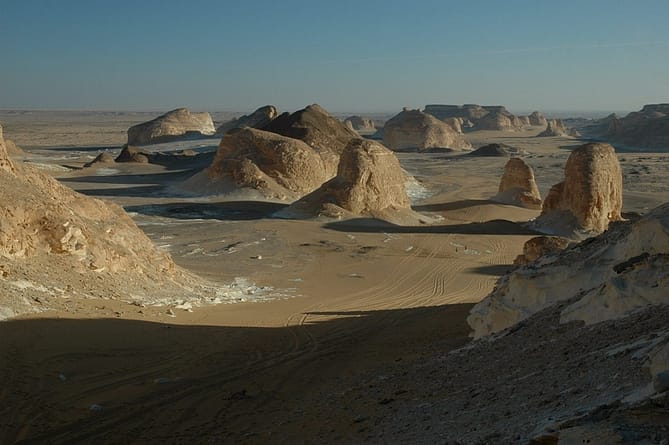 brown rocks in a desert under a blue sky  