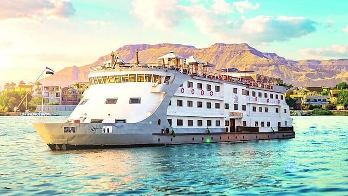 a white ship on a blue river and one of the most beautiful spots to tour in Egypt