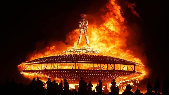A large burning man figure on a space craft
