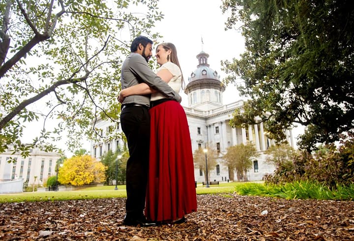A male and female couple holding each other's waist in the South Carolina State House