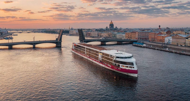 A long white and pink cruise ship on the Volga River 