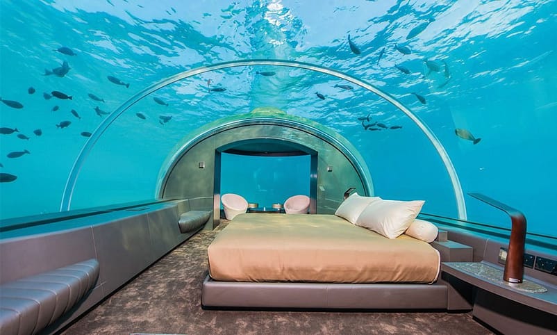 Muraka Suite - The Conrad - $50,000A large luxury bed and pillows inside a room in an undersea hotel apartment
