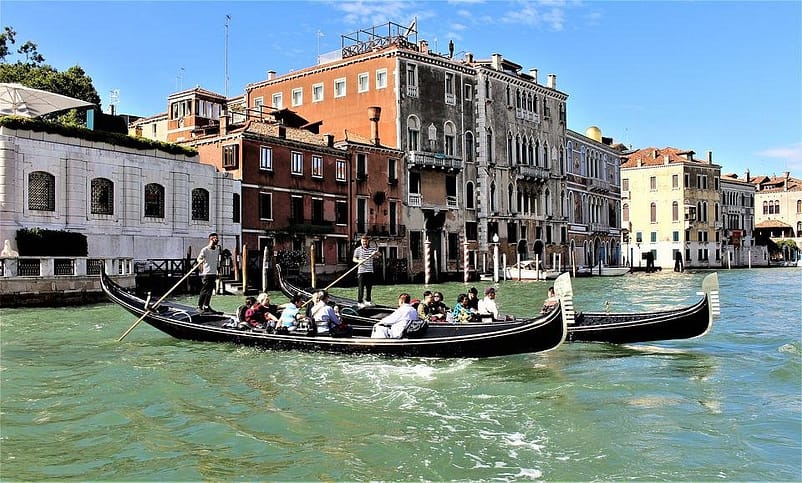 A group of people on a canoe in Gondola Ride, Venice