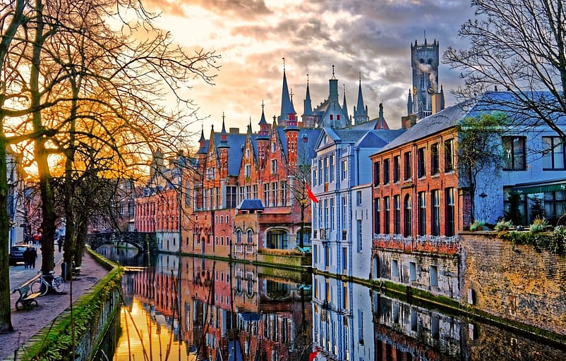 A colorful city in Bruges, Belgium, with trees and flowing waters