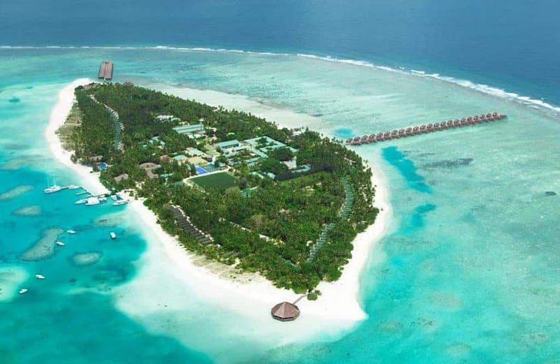 An aerial view of Meeru Island, Maldives, showing a beautiful island with trees and buildings