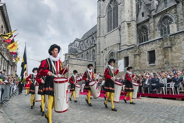 People marching in costumes with drums